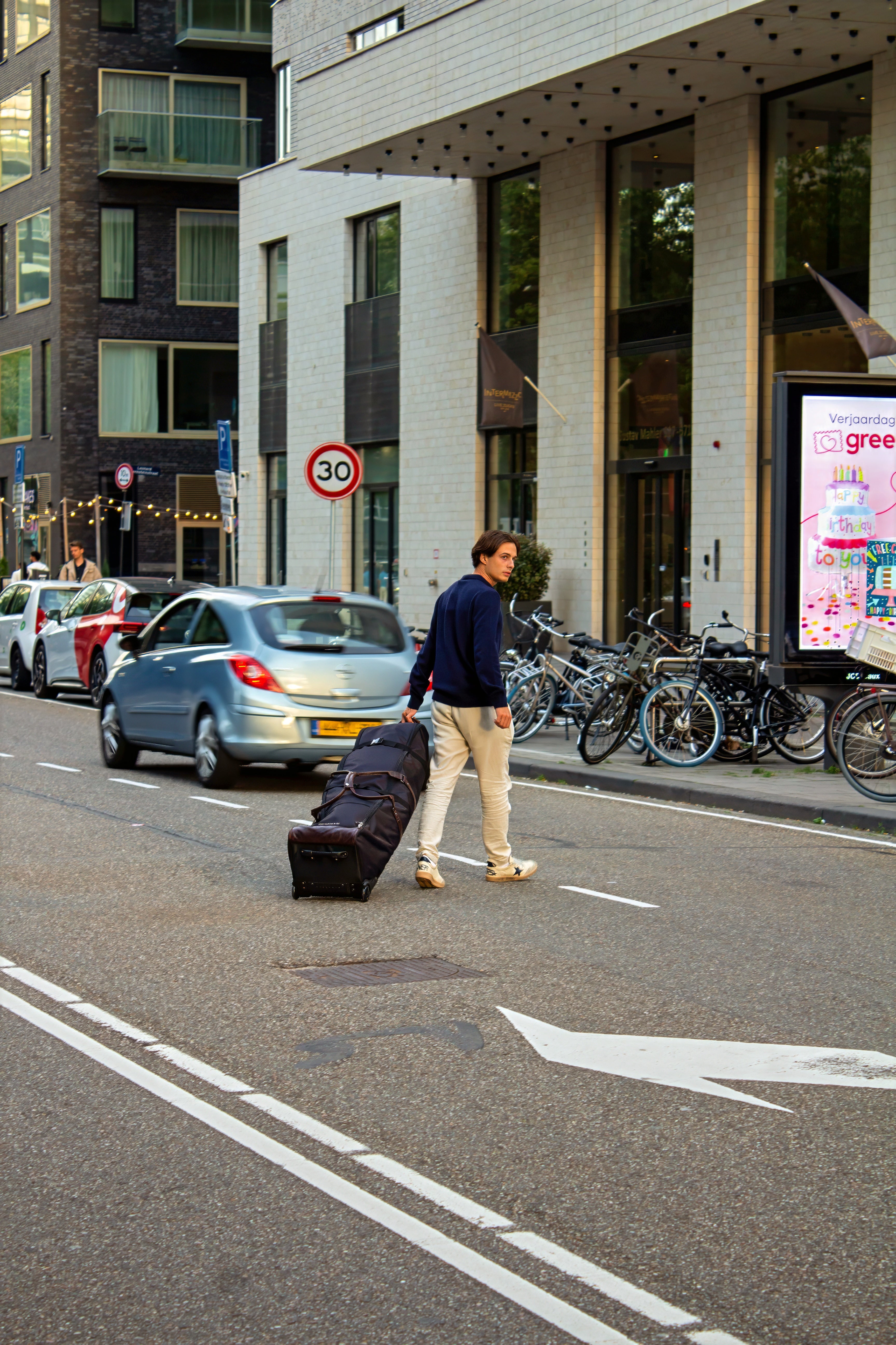 Man walking through the city with a John Martin Golf Travel Bag.