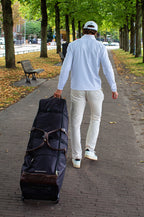 Man walking with the John Martin Golf Travel Bag.